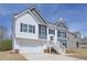Charming two-story home with white and gray siding, front-facing garage, and manicured lawn at 500 Charleston Pl, Villa Rica, GA 30180