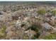 The aerial view shows the neighborhood with mature trees and homes spaced along winding roads at 650 Hunterhill Ct, Roswell, GA 30075