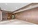 Finished basement with a brick fireplace, carpeted floors, and modern recessed lighting at 650 Hunterhill Ct, Roswell, GA 30075