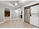 The basement features appliances, wood-look flooring, and access to a brick-walled room with a fireplace at 650 Hunterhill Ct, Roswell, GA 30075