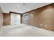 Finished basement with a window, barn door, and neutral carpet at 650 Hunterhill Ct, Roswell, GA 30075
