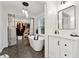 Bright bathroom with a soaking tub, a closet, and vanity featuring modern fixtures at 650 Hunterhill Ct, Roswell, GA 30075