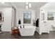 Bright bathroom with a soaking tub, a closet, and vanity featuring modern fixtures at 650 Hunterhill Ct, Roswell, GA 30075