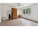 Bright bedroom featuring hardwood floors, large window with tree view, and classic wardrobe at 650 Hunterhill Ct, Roswell, GA 30075