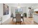 Dining room with hardwood floors and view into adjacent kitchen with stainless steel appliances at 650 Hunterhill Ct, Roswell, GA 30075
