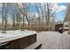 Exterior deck with a luxurious hot tub, offering a relaxing retreat overlooking the wooded backyard at 650 Hunterhill Ct, Roswell, GA 30075