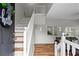 Welcoming entryway featuring a staircase with wooden steps, white risers, and a white railing at 1923 Hamby Place Nw Dr, Acworth, GA 30102