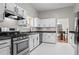 Modern kitchen features white cabinets, granite countertops, and stainless steel appliances at 1923 Hamby Place Nw Dr, Acworth, GA 30102