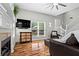 Bright living room with hardwood floors, a fireplace, lots of light and leather seating at 1923 Hamby Place Nw Dr, Acworth, GA 30102
