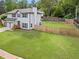 Expansive green yard with wooden privacy fence surrounding the property and a two car garage at 1923 Hamby Place Nw Dr, Acworth, GA 30102