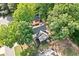 Aerial view of a home surrounded by mature trees, featuring a well-maintained backyard with a patio area at 3376 Hickory Ln, Powder Springs, GA 30127