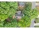 Aerial view of a lovely home surrounded by lush greenery and mature trees on a private street, complete with a backyard at 3376 Hickory Ln, Powder Springs, GA 30127