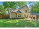 Backyard with a well-maintained lawn, patio with outdoor seating and landscaping provides the perfect outdoor living space at 3376 Hickory Ln, Powder Springs, GA 30127