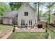 This backyard features a patio with seating, a lush lawn, and landscaping, perfect for relaxing or entertaining at 3376 Hickory Ln, Powder Springs, GA 30127