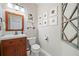 Charming powder room with wood vanity, framed art, and decorative mirror at 3376 Hickory Ln, Powder Springs, GA 30127