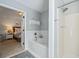 Bathroom features a bathtub with subway tile, a shower and open doorway to a bedroom at 3376 Hickory Ln, Powder Springs, GA 30127