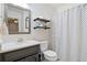 Bright bathroom with marble countertop, gray vanity, decorative towels and modern shower curtain at 3376 Hickory Ln, Powder Springs, GA 30127