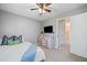 Bedroom with white dresser, ceiling fan and open doorway to bathroom and closet at 3376 Hickory Ln, Powder Springs, GA 30127