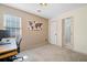 Bedroom with neutral-toned wallpaper, desk and chair, and access to ensuite bathroom at 3376 Hickory Ln, Powder Springs, GA 30127