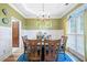 Charming dining area with a wood table, chandelier, and a large window offering natural light at 3376 Hickory Ln, Powder Springs, GA 30127