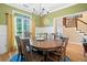 Elegant dining room with hardwood floors, crown molding, and a large wood table at 3376 Hickory Ln, Powder Springs, GA 30127
