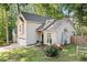 Charming two-story traditional home showcases a well-manicured lawn, lush landscaping, and an attached two-car garage at 3376 Hickory Ln, Powder Springs, GA 30127