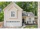 Charming home featuring an attached two-car garage and complemented by lush landscaping at 3376 Hickory Ln, Powder Springs, GA 30127