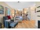 Bright living room with hardwood floors, cozy seating, and staircase view at 3376 Hickory Ln, Powder Springs, GA 30127