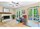 Inviting living room featuring a brick fireplace, hardwood floors, and a large window at 3376 Hickory Ln, Powder Springs, GA 30127