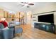 Open-concept living room with hardwood floors, comfortable seating, and a view of the staircase at 3376 Hickory Ln, Powder Springs, GA 30127