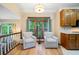 Bright living room nook with hardwood floors, two armchairs, and a window view of the trees at 3376 Hickory Ln, Powder Springs, GA 30127