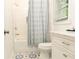Well-lit bathroom with a shower-tub combo, patterned floor, and white vanity at 398 Nw Wester Blvd, Atlanta, GA 30314