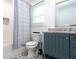 Bathroom featuring stylish floor tiles, blue vanity with granite countertop, and shower at 398 Nw Wester Blvd, Atlanta, GA 30314