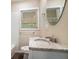 Bathroom featuring a granite vanity top, decorative mirror and tiled wall at 4004 Knightsbridge Nw Rd, Kennesaw, GA 30144