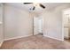 Bedroom with tan carpet, neutral paint, ceiling fan, and attached bathroom at 4004 Knightsbridge Nw Rd, Kennesaw, GA 30144