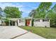 Charming single-story home with red front door, covered parking and fresh landscaping at 4004 Knightsbridge Nw Rd, Kennesaw, GA 30144