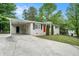Single-story home featuring a painted brick facade, driveway, and convenient covered parking at 4004 Knightsbridge Nw Rd, Kennesaw, GA 30144