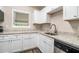 Bright kitchen featuring white cabinets, granite countertops, and stainless steel dishwasher at 4004 Knightsbridge Nw Rd, Kennesaw, GA 30144