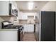 Well lit kitchen featuring stainless steel appliances, granite countertops, and white cabinets at 4004 Knightsbridge Nw Rd, Kennesaw, GA 30144
