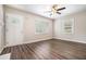 Living room featuring hardwood floors, neutral paint, ceiling fan, and two windows at 4004 Knightsbridge Nw Rd, Kennesaw, GA 30144