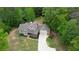 Aerial view of the property featuring a well-manicured lawn and mature trees at 547 Ellington Rd, Oxford, GA 30054