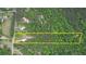 Aerial view of the property featuring a well-manicured lawn and mature trees at 547 Ellington Rd, Oxford, GA 30054