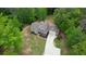 Aerial view of a home with a long driveway surrounded by lush trees at 547 Ellington Rd, Oxford, GA 30054