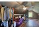 Finished attic space with hardwood floors, closet space, fan, and natural light coming from the window at 547 Ellington Rd, Oxford, GA 30054