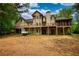 Spacious backyard featuring a deck, screened porch, and a walk-out basement at 547 Ellington Rd, Oxford, GA 30054