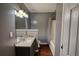 Bathroom featuring a vanity with white sink, toilet and shower/tub at 547 Ellington Rd, Oxford, GA 30054