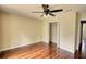 Simple bedroom features hardwood floors, a ceiling fan, and a closet at 547 Ellington Rd, Oxford, GA 30054