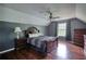 Bedroom featuring hardwood floors, ceiling fan and a window with curtains at 547 Ellington Rd, Oxford, GA 30054