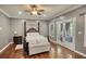 Bedroom featuring hardwood floors, natural light, ceiling fan, and a four-poster bed at 547 Ellington Rd, Oxford, GA 30054