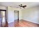Clean bedroom with wooden floors, a ceiling fan, and a closet at 547 Ellington Rd, Oxford, GA 30054